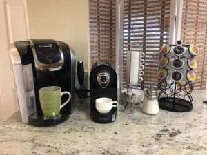 a coffeemaker and coffee maker on a counter at Oak Retreat by Yosemite National Park in Coarsegold