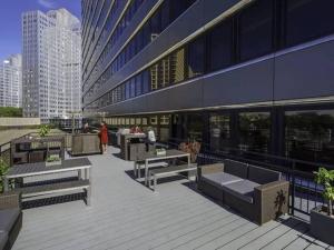 匹兹堡Luxe City Views in DT Pittsburgh VALET GYM WIFI的前面有长椅和桌子的建筑