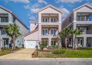 a large house with palm trees in front of it at Arborgate Gate Away At 7971 Double Gate Dr By Pkrm in Pensacola
