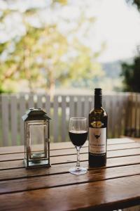 a bottle of wine and a glass on a table at Forgotten Valley Guesthouse in Gunderman