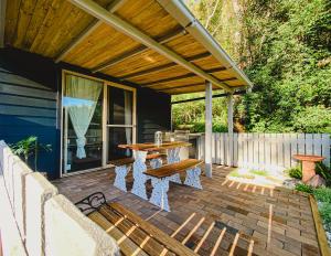 a patio with a table and benches on it at Forgotten Valley Guesthouse in Gunderman