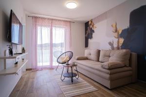 a living room with a couch and a table at Laurel Apartments in Tisno