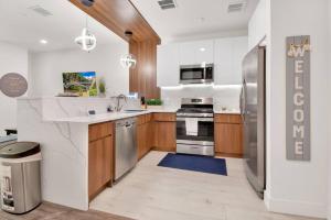 a kitchen with wooden cabinets and stainless steel appliances at Rhythm & Blues Free Park 2BD-2BTH Near EWR-Penn-Prudential in Newark