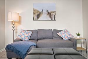 a living room with a couch and a picture of a pier at Walk to Jacksonville Beach, 10min to Mayo in Jacksonville Beach