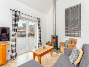 a living room with a couch and a fireplace at Old School House 