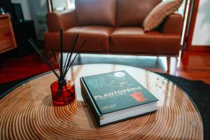 a book on a coffee table in a living room at Paperbark Retreat in Cooktown
