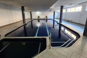 a large swimming pool in a building with a pool at Impressive Centrally Located Penthouse in Sydney