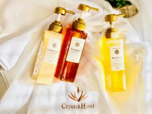 three bottles of essential oils sitting on a white towel at Doutonbori Crystal Hotel Ⅱ in Osaka