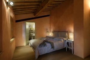 a bedroom with a large bed and a bathroom at Agriturismo San Giusto in Sovicille