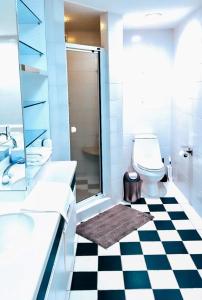 a bathroom with a black and white checkered floor at Highrise luxury two bedroom condo in Downtown Atlanta within minutes!! in Atlanta