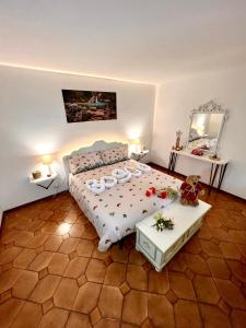 a bedroom with a bed and two tables and a mirror at Il Bosco e Il Borgo Guest House Subiaco in Subiaco