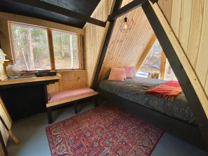 a small room with a bed and a window at Sailor Springs Glamping in Bayfield