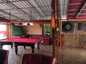a room with a pool table and a couch at The Eighty8 in Phnom Penh