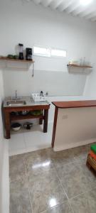 a kitchen with a sink and a wooden table at Guest House Villa Hortensia in Santa Marta