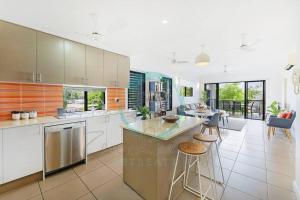a large kitchen with a large island in the middle at ZEN NOMAD 2-BR Nightcliff Apt Near Markets & Shops in Nightcliff