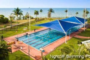 a large swimming pool with a blue covering at ZEN NOMAD 2-BR Nightcliff Apt Near Markets & Shops in Nightcliff