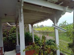 a pergola in a garden with a hill in the background at Villa Galaxy Resort C15 in Cipanas