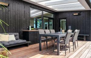 a dining room with a table and chairs at Stunning Home In Kalundborg With House Sea View in Kalundborg