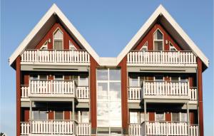 a building with two balconies on the side of it at Cozy Apartment In Rechlin With Sauna in Rechlin
