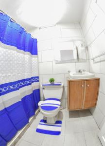 a bathroom with a toilet and a sink at las carreras centro D la ciudad in Santiago de los Caballeros