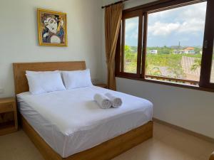 Postel nebo postele na pokoji v ubytování Bombora Balangan Resort