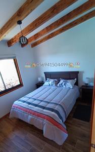 a bedroom with a bed and a window at Cabaña Playa Rosada in Valdivia