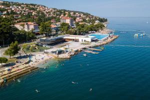 an aerial view of a beach with people in the water at Villa Pablo City Studios Koper in Koper