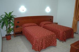 Cama o camas de una habitación en Real Asturias Hotel