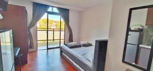 a bedroom with a bed and a large window at Mega tower 3 staycation in Baguio