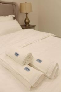 a white bed with white towels on it at فيلا عصرية بمدخل خاص و مسبح in Riyadh