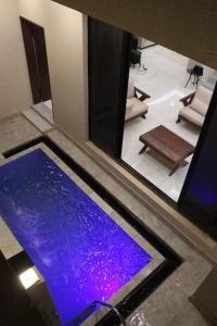 a swimming pool with purple water in a room at فيلا عصرية بمدخل خاص و مسبح in Riyadh