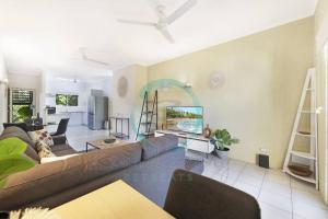 a living room with a couch and a table at ZEN Westralia: 2-BR Cozy Inner-City Apt Near Shops in Stuart Park