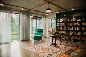 a living room with a library with chairs and a table at LEE Garden - Venuestay in Hanoi