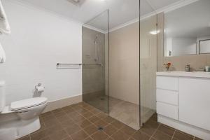 a bathroom with a shower and a toilet and a sink at Oxley Court Serviced Apartments in Canberra +23 photos