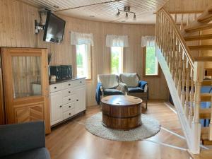 a living room with a coffee table and stairs at Villa Muu, LaatuLomat in Juva