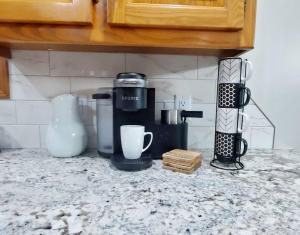 a kitchen counter with a coffee maker on a counter top at Freshly Remodeled Quaint Home in Springfield