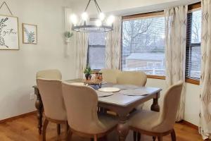 a dining room with a table and chairs and a window at Freshly Remodeled Quaint Home in Springfield