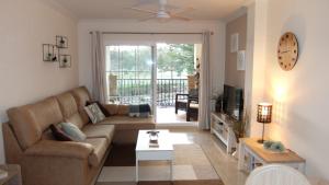 a living room with a couch and a tv at Dream Apartment in Mijas Golf Limonar in Mijas Costa