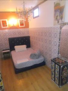 a room with a small dog bed in a room at chambre priver in Rabat