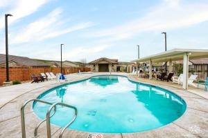 a large swimming pool with blue water in a yard at Desert Rose home in Washington