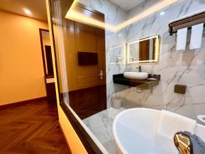 a bathroom with a white sink and a mirror at An Khang Hotel Sapa in Sa Pa