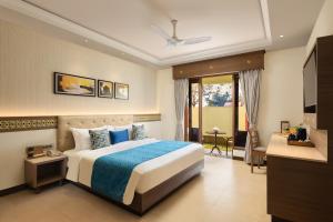 a hotel room with a bed and a television at Fortune Resort Benaulim Goa - Member ITC Hotels' Group in Benaulim +42 photos