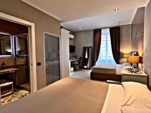 a hotel room with two beds and a window at Fabio Massimo Guest House in Rome