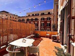 a patio with a table and chairs on a balcony at Fabio Massimo Guest House in Rome