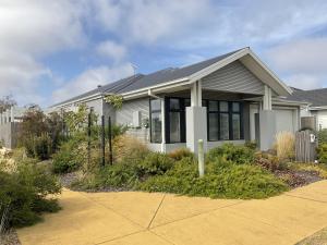 a white house with black shutters at NAUTILUS in Point Lonsdale