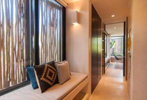 a room with a bench with pillows and a window at Spectacular Villa Gaia/PH/private pool in Tulum +54 photos