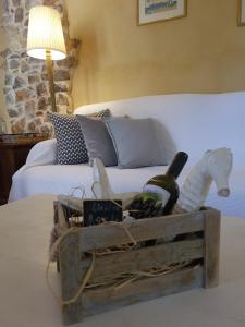 a wooden crate filled with wine bottles and a horse statue at Villa Agali. in Agia Anna +41 photos