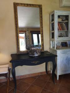 a mirror sitting on top of a table in a room at Villa Agali. in Agia Anna