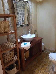 a bathroom with a sink and a toilet at Villa Agali. in Agia Anna