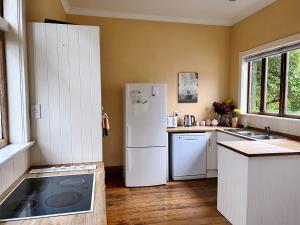 a kitchen with a white refrigerator and a sink at NO PARTY ALLOWED, Peaceful, Spacious, central Petone, free unlimited Fibre Wi-Fi & free parking in Lower Hutt